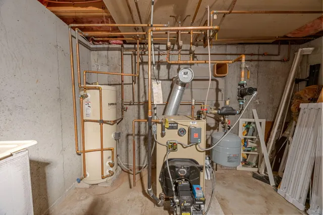 an aerial view of residential houses with outdoor space and trees