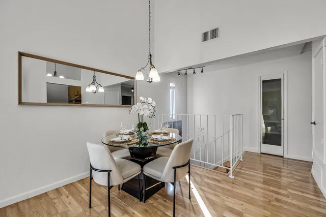 a view of a dining room with furniture and wooden floor
