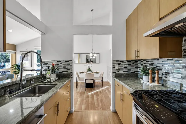 a kitchen with sink a stove and cabinets