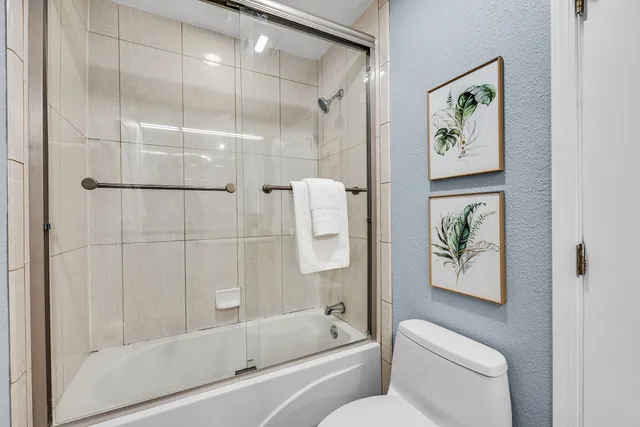 a bathroom with a shower and a toilet