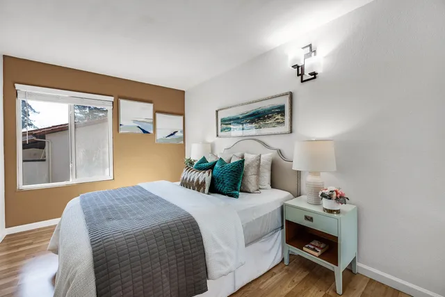 a bedroom with a bed and wooden floor