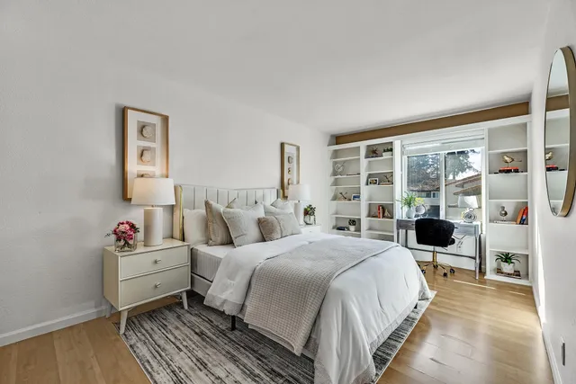 a bedroom with a bed and wooden floor