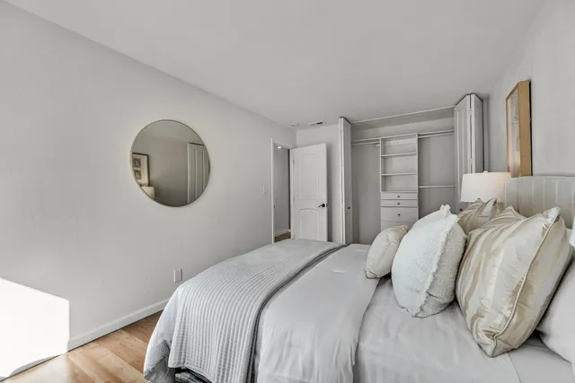 a bedroom with a bed and a mirror