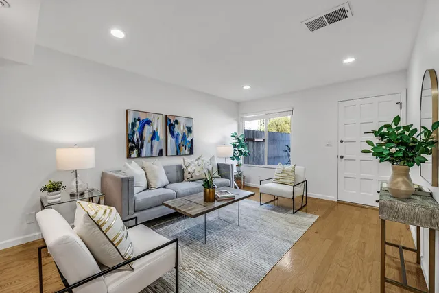 a living room with furniture potted plant and a couch