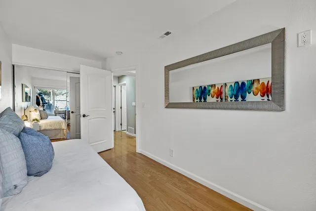 a living room with furniture and a book shelf