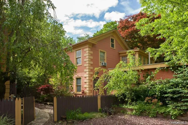 front view of a house with a tree