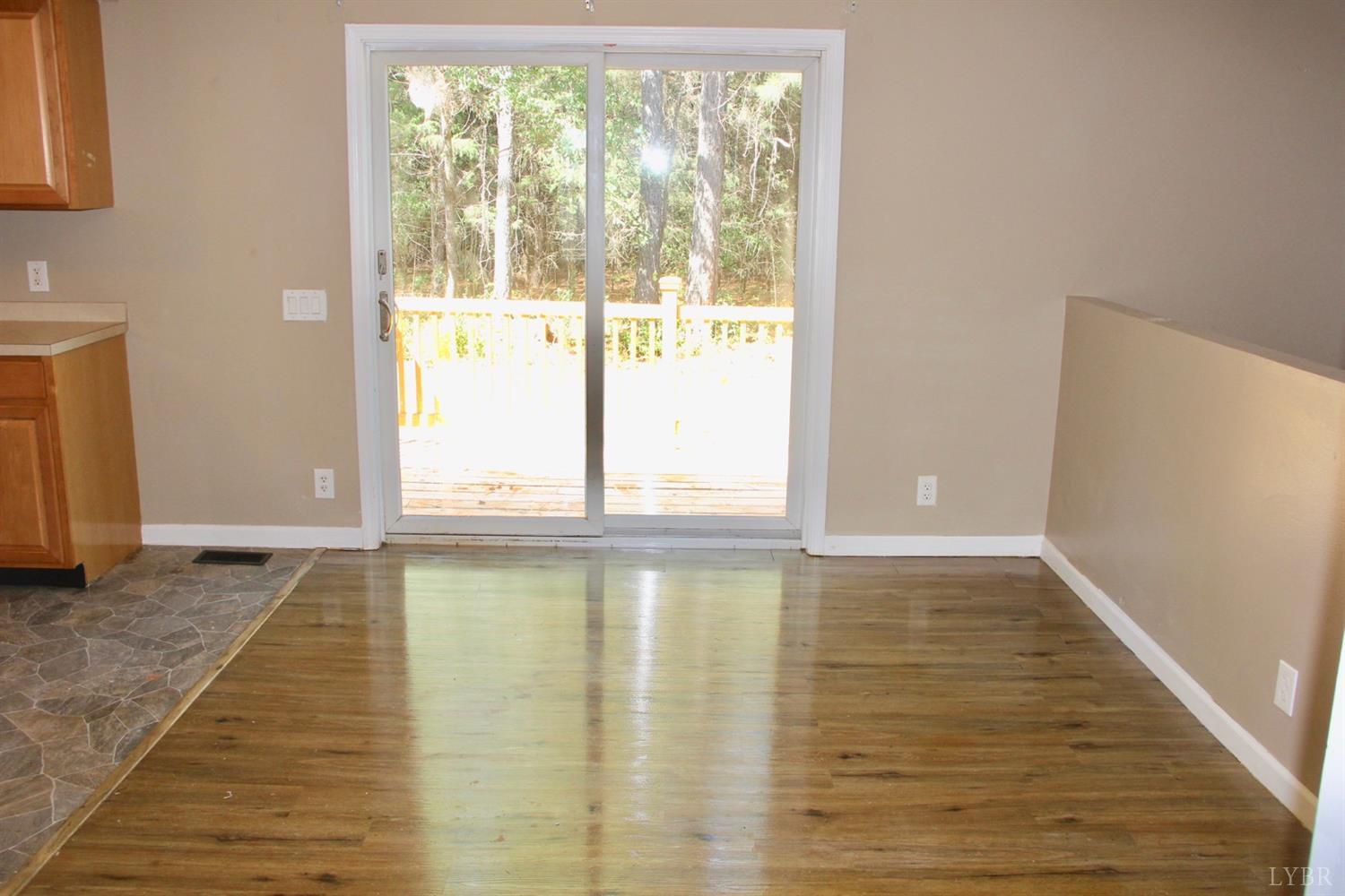 792 Fletchers Level Road Amherst, VA 24521 - Photo 13 of 40 a view of an empty room with wooden floor and a window