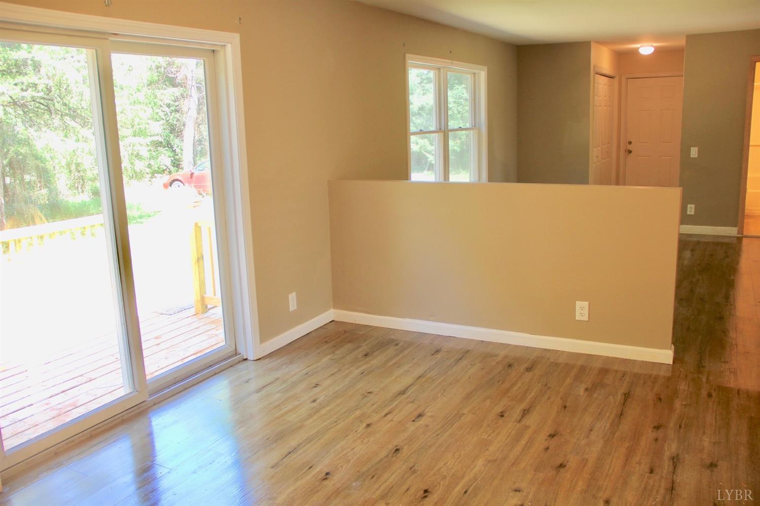 792 Fletchers Level Road Amherst, VA 24521 - Photo 14 of 40 an empty room with wooden floor and windows