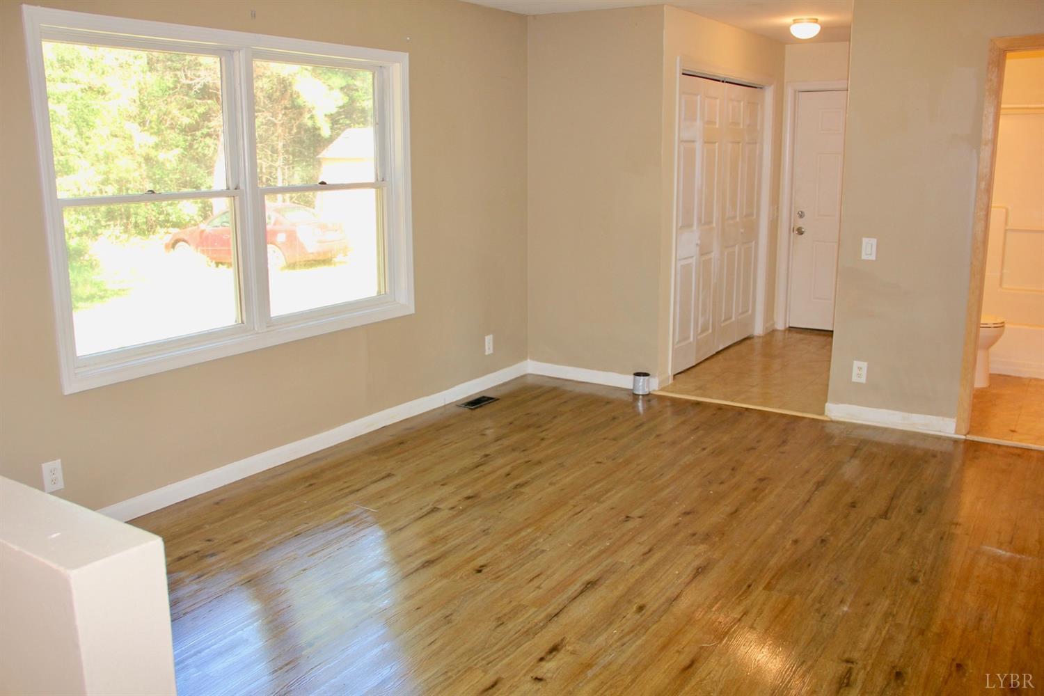 792 Fletchers Level Road Amherst, VA 24521 - Photo 15 of 40 a view of a room with wooden floor and window
