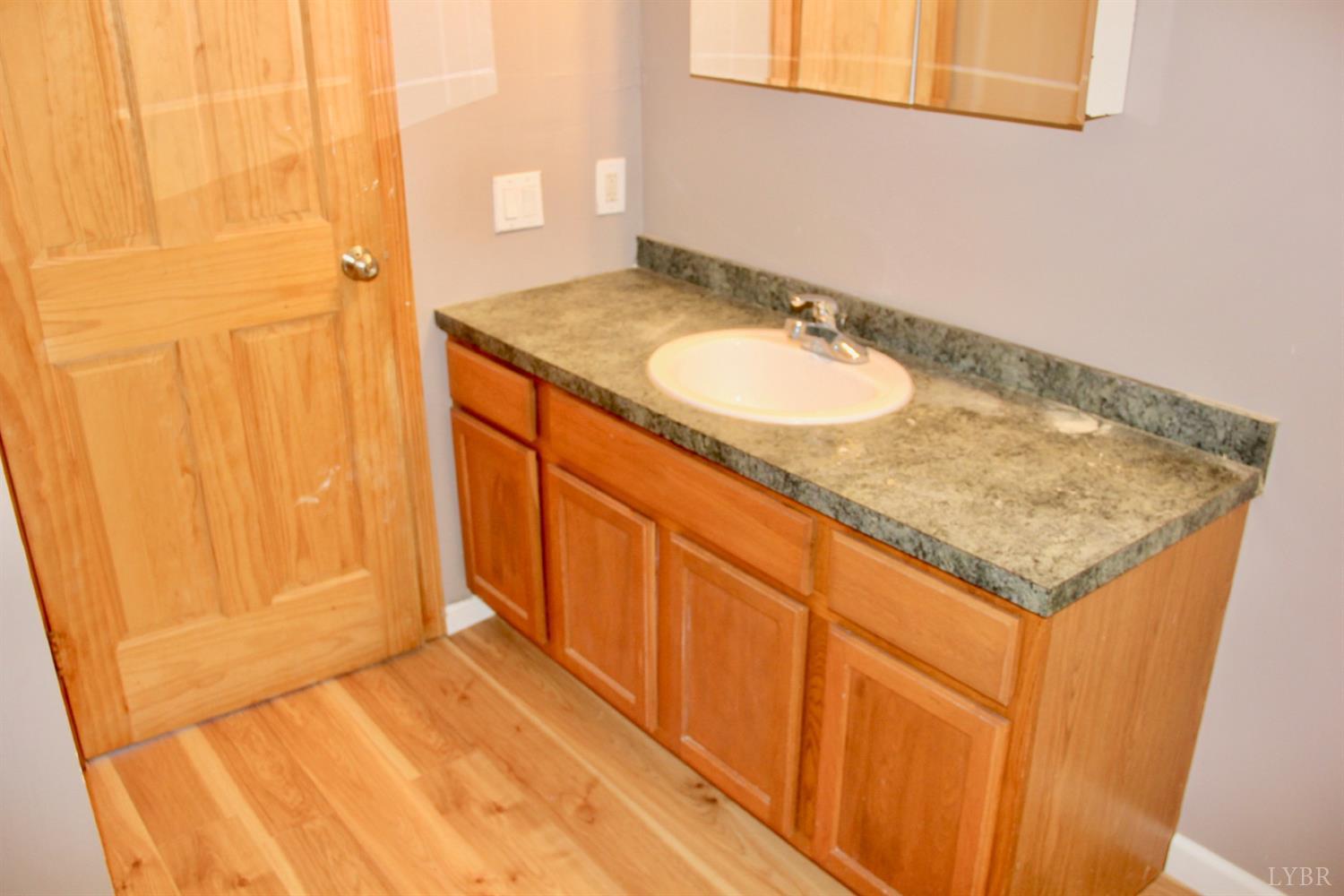 792 Fletchers Level Road Amherst, VA 24521 - Photo 18 of 40 a bathroom with a granite countertop sink and a mirror