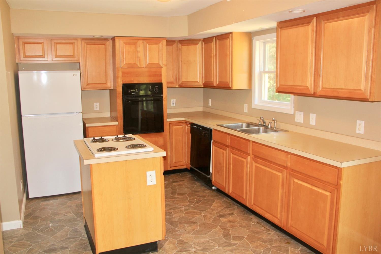 792 Fletchers Level Road Amherst, VA 24521 - Photo 9 of 40 a kitchen with a stove a sink and a refrigerator