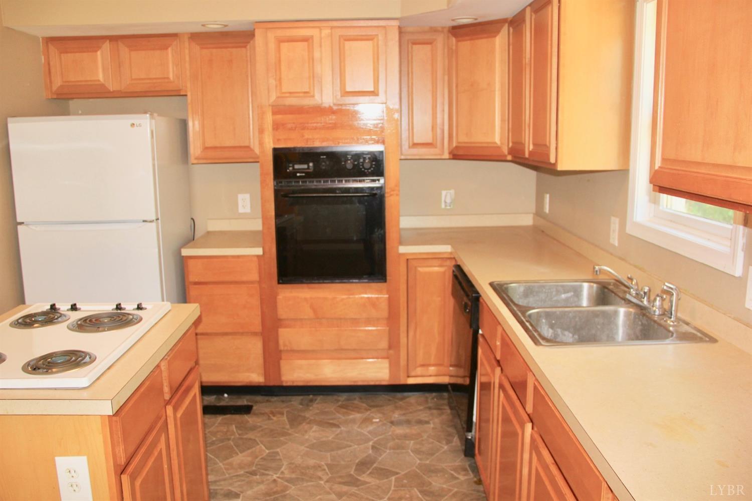 792 Fletchers Level Road Amherst, VA 24521 - Photo 10 of 40 a kitchen with a sink stove and refrigerator