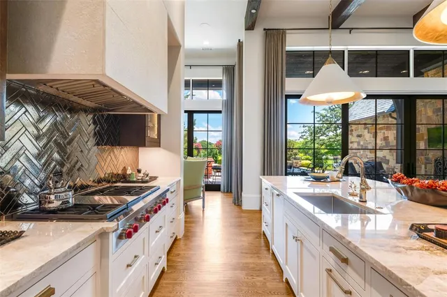 a kitchen with stainless steel appliances granite countertop a stove and a sink