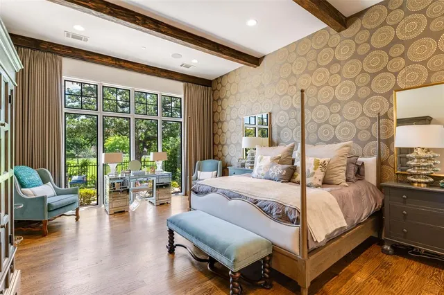 a bedroom with a bed and large windows