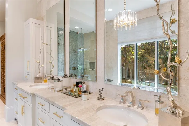 a bathroom with double vanity and a mirror