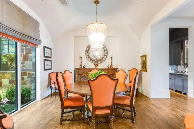 a dining room with furniture and wooden floor
