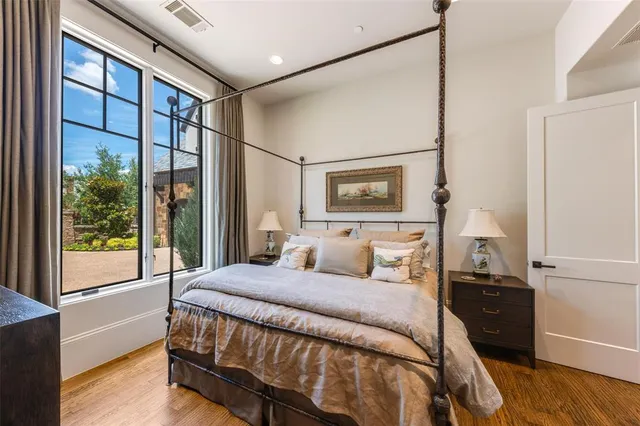 a bedroom with a bed and a large window