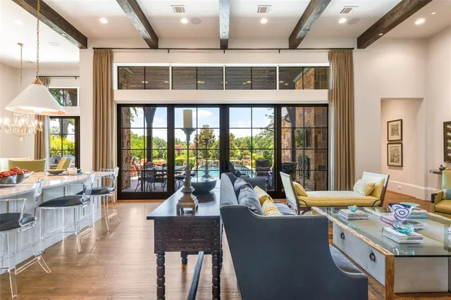 a living room with furniture and floor to ceiling windows