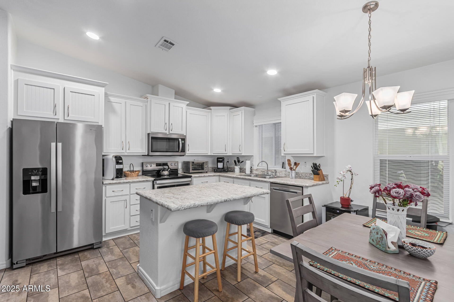 650 North Hawes Road, Unit 3815 Mesa, AZ 85207 - Photo 11 of 29 a kitchen with a sink a refrigerator and cabinets