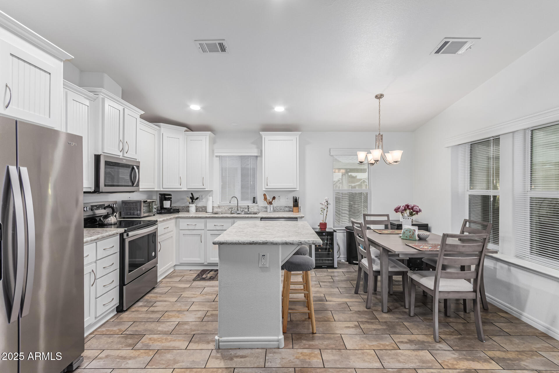 650 North Hawes Road, Unit 3815 Mesa, AZ 85207 - Photo 13 of 29 a large kitchen with kitchen island a sink table and chairs