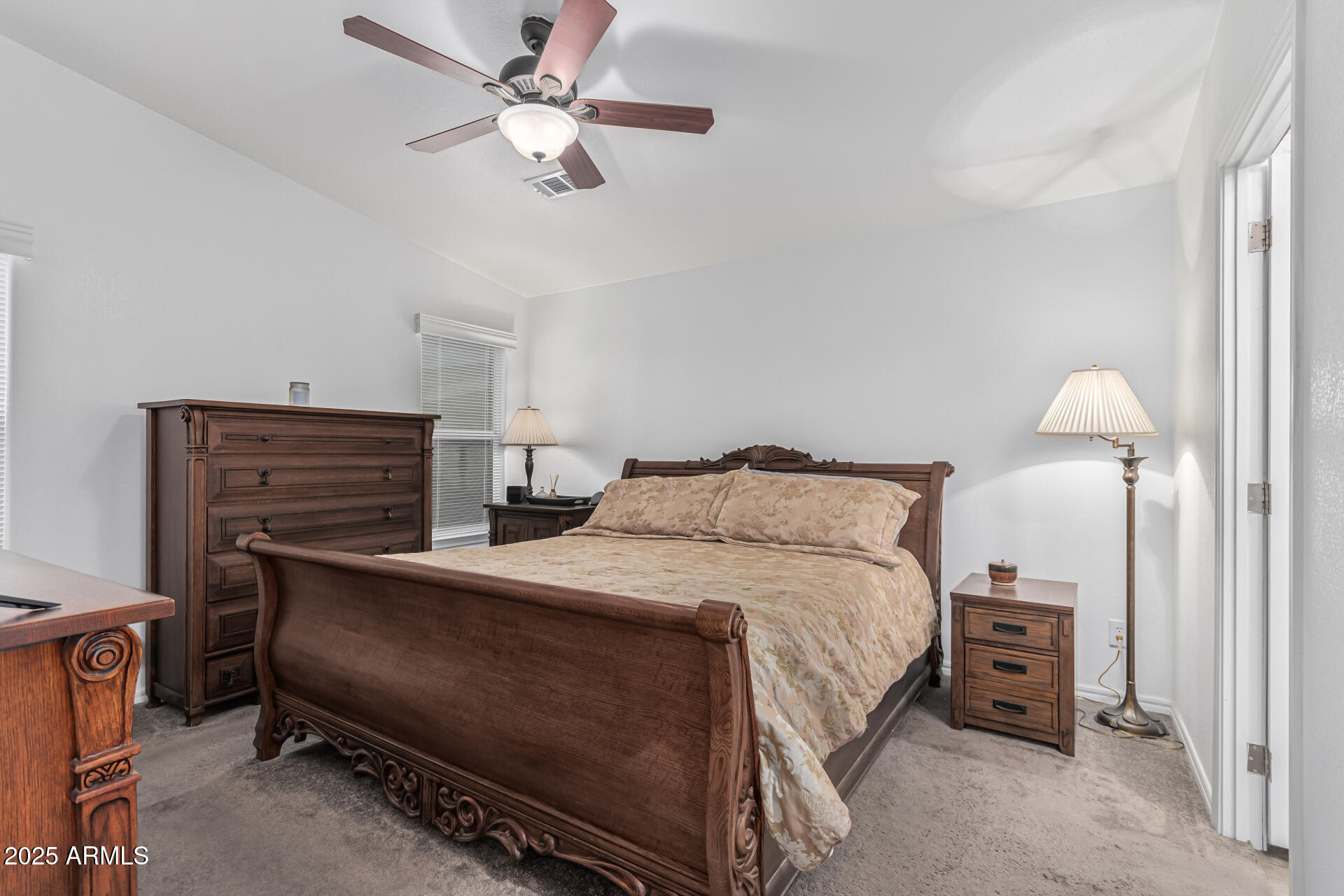 650 North Hawes Road, Unit 3815 Mesa, AZ 85207 - Photo 15 of 29 a bedroom with a bed and a chandelier