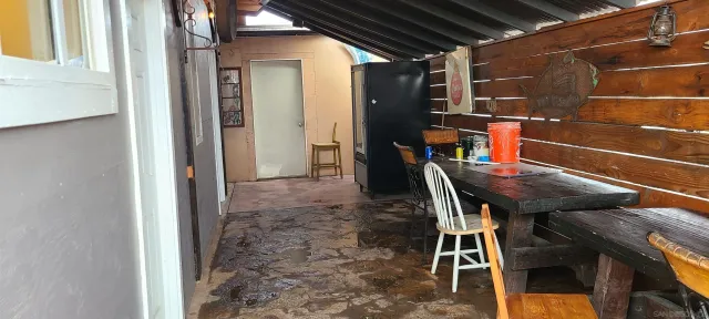 a view of a backyard with table and chairs with wooden floor