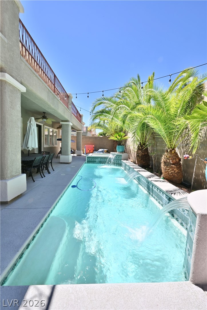 2729 Kildrummie Street Henderson, NV 89044 - Photo 4 of 42 An inviting backyard oasis offers a sparkling pool with water features and a covered patio for outdoor enjoyment.