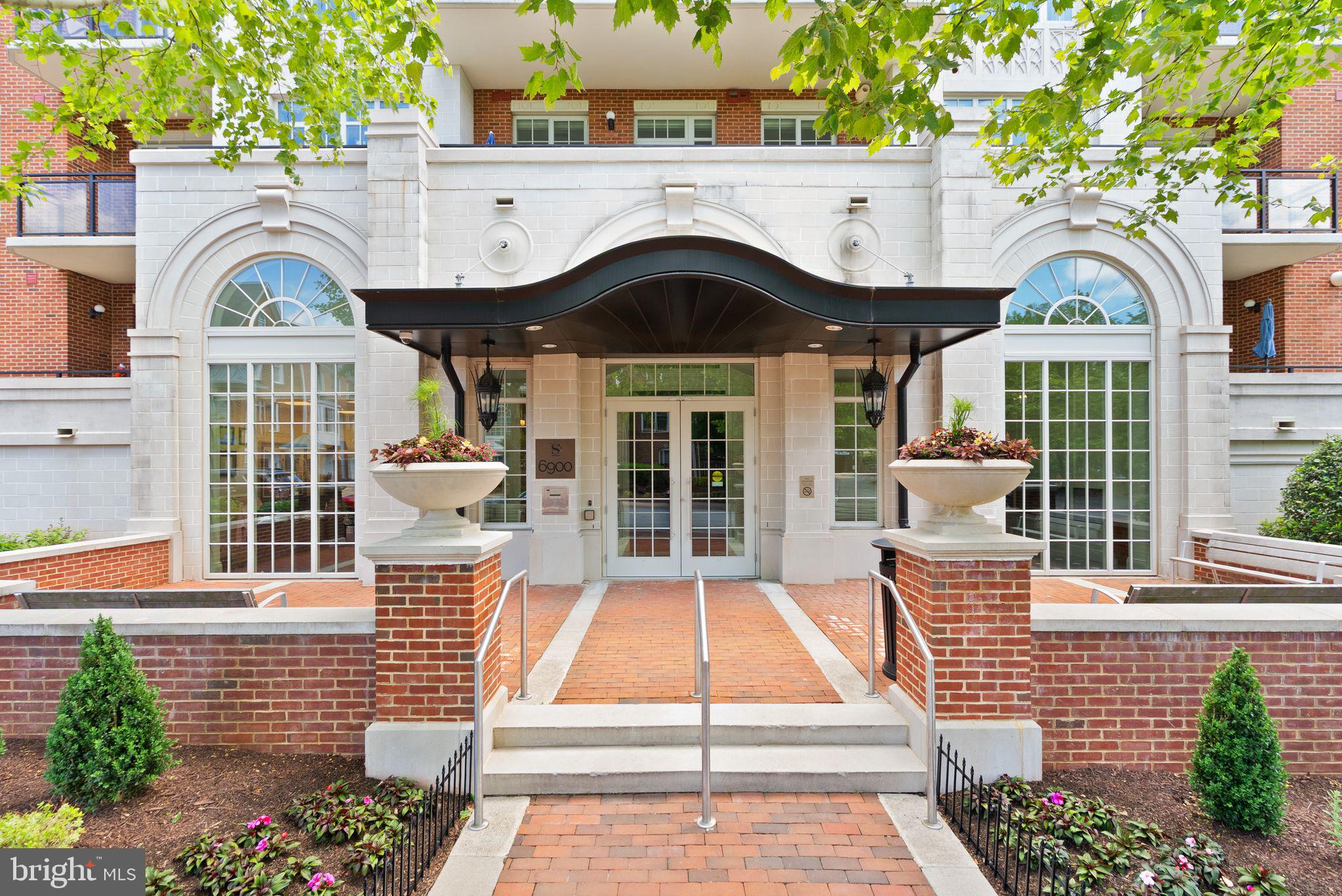 6900 Fleetwood Road, Unit 415 McLean, VA 22101 - Photo 3 of 51 a front view of a house with a yard