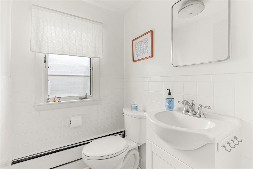 23 Cottonwood Road Wellesley, MA 02482 - Photo 16 of 19 a bathroom with a sink a toilet and a mirror