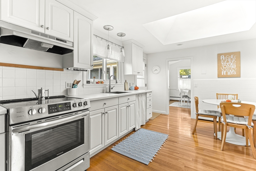 23 Cottonwood Road Wellesley, MA 02482 - Photo 7 of 19 a kitchen with stainless steel appliances white cabinets and a stove top oven