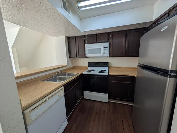 a kitchen with a refrigerator and a stove