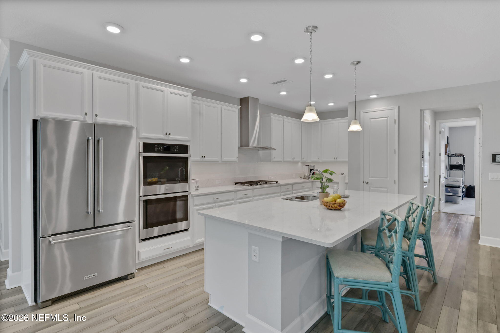 146 Clarendon Road St. Johns, FL 32259 - Photo 16 of 59 a kitchen with a white center island cabinets and stainless steel appliances