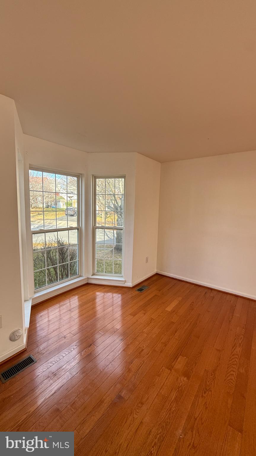 11 Hunters Forge Court Owings Mills, MD 21117 - Photo 16 of 139 wooden floor in an empty room with a window