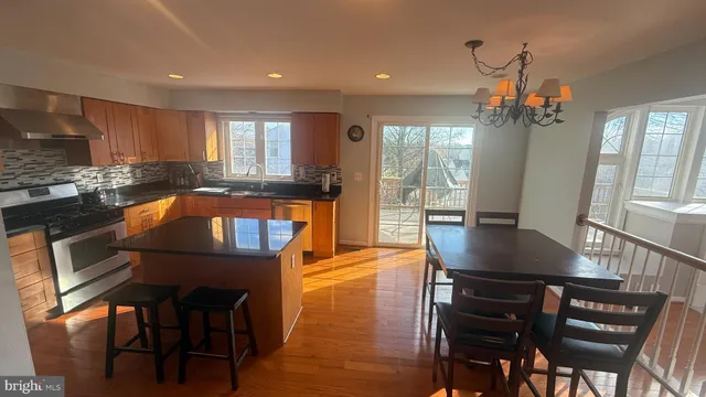 a view of a hallway with wooden floor and windows