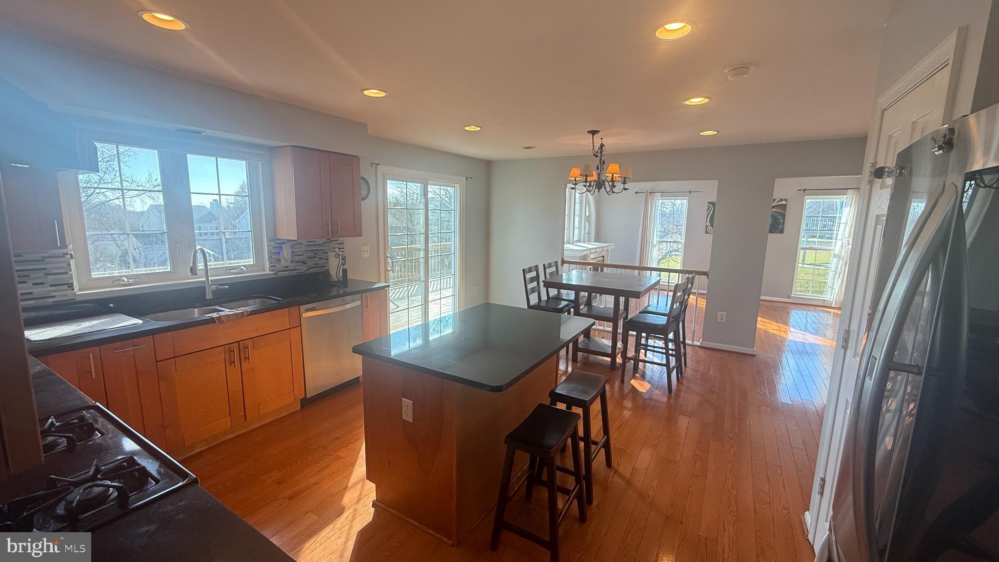 11 Hunters Forge Court Owings Mills, MD 21117 - Photo 24 of 139 a kitchen with stainless steel appliances granite countertop sink refrigerator dining table and chairs