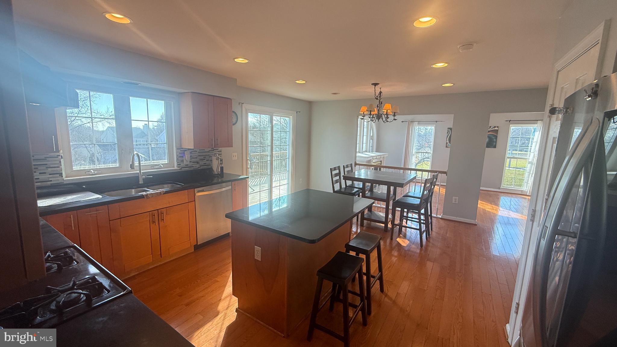 11 Hunters Forge Court Owings Mills, MD 21117 - Photo 25 of 139 a kitchen with stainless steel appliances granite countertop sink refrigerator dining table and chairs