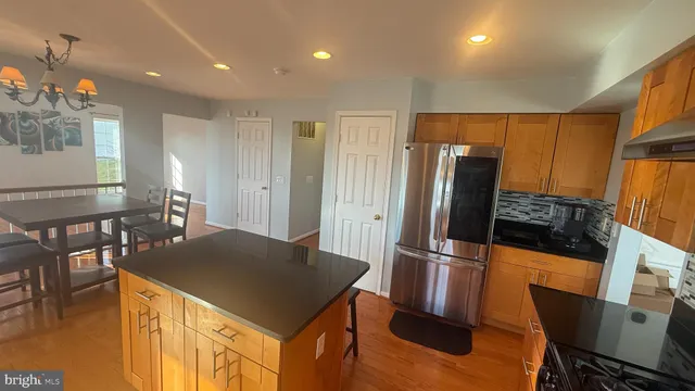 a dining room filled chandelier and wooden floor