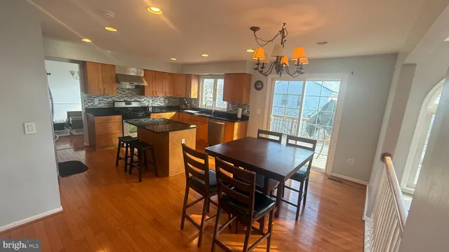 a view of an empty room and chandelier fan