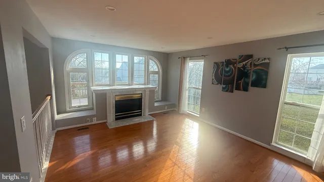 a living room with furniture flat screen tv and rug floor