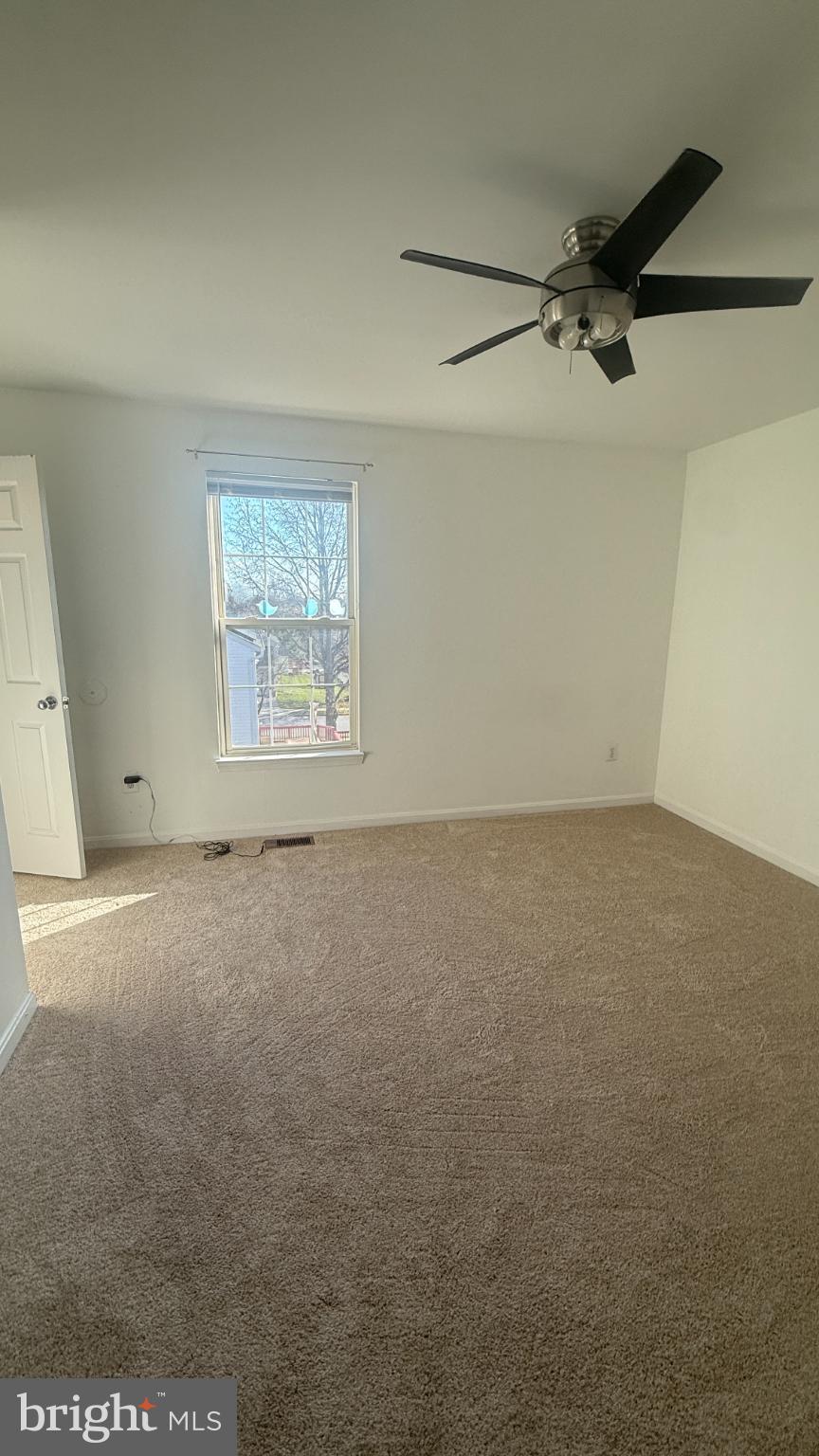 11 Hunters Forge Court Owings Mills, MD 21117 - Photo 87 of 139 an empty room with a window and a ceiling fan