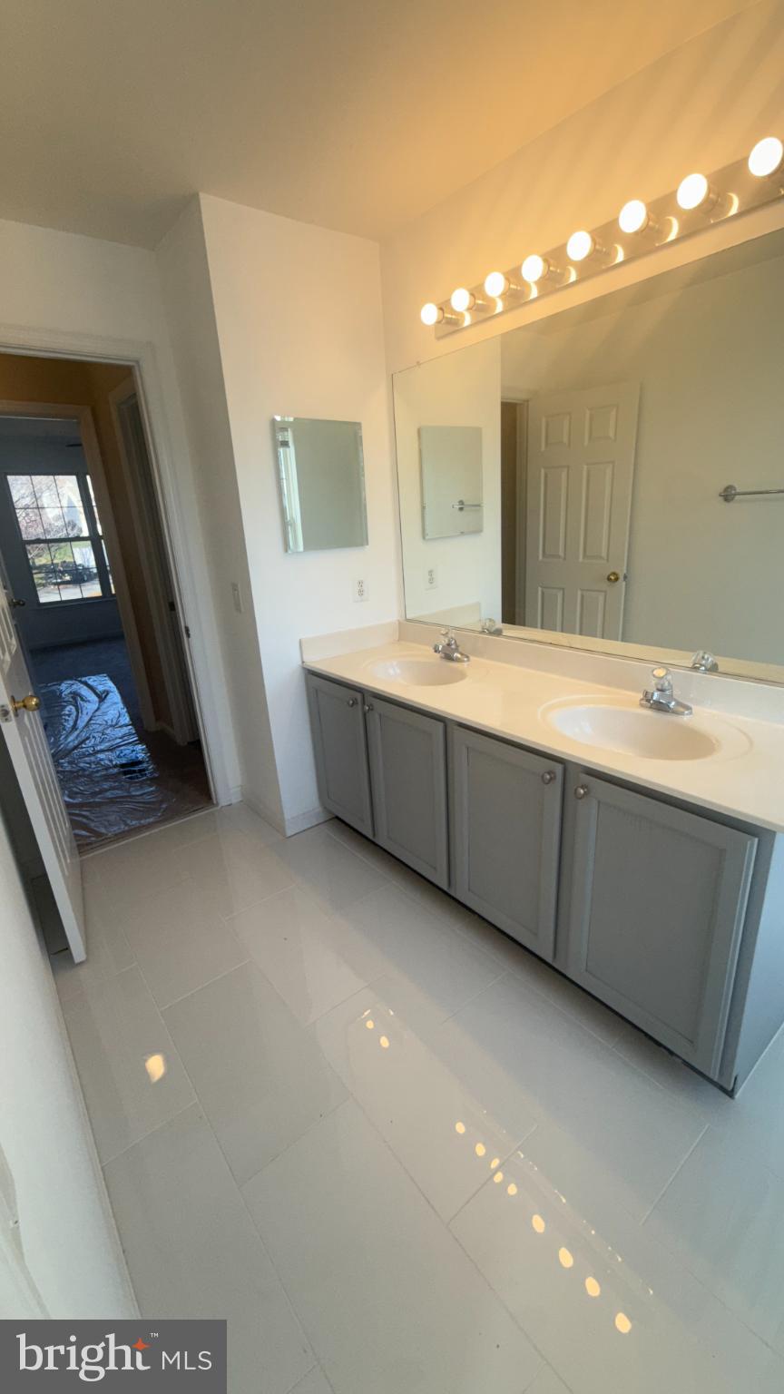 11 Hunters Forge Court Owings Mills, MD 21117 - Photo 93 of 139 a bathroom with a double vanity sink and a mirror