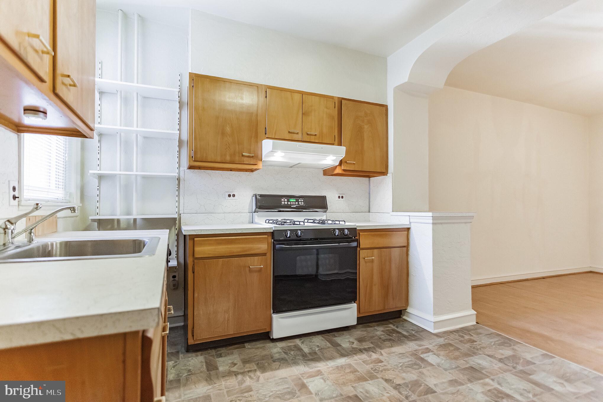 513 Pine Street Philadelphia, PA 19106 - Photo 15 of 32 a kitchen with a stove top oven sink and cabinets