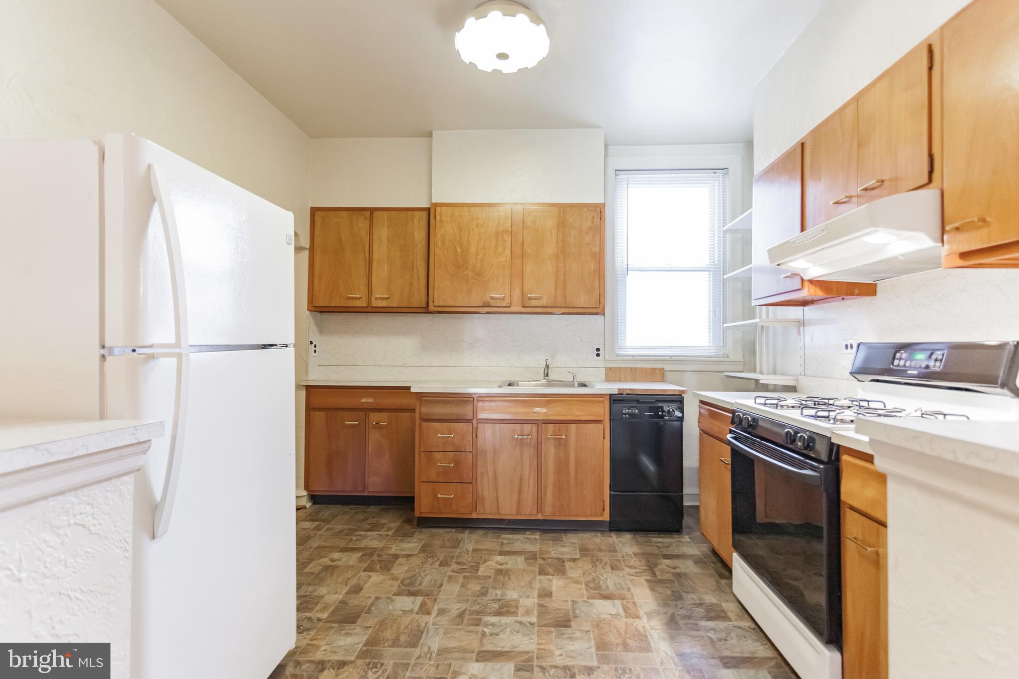 513 Pine Street Philadelphia, PA 19106 - Photo 17 of 32 a kitchen with stainless steel appliances granite countertop a stove a sink and a refrigerator