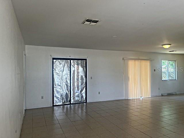 12 Pine Course Way Ocala, FL 34472 - Photo 3 of 29 an empty room with wooden floor and windows