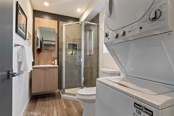 a bathroom with a sink a toilet and shower