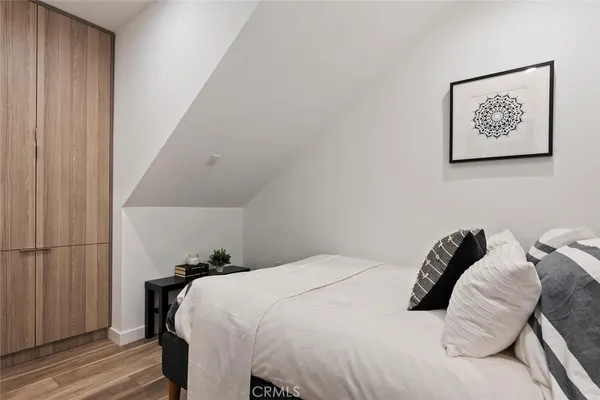 a bedroom with a bed and a painting on the wall