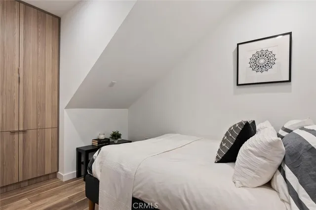 a bedroom with a bed and a painting on the wall