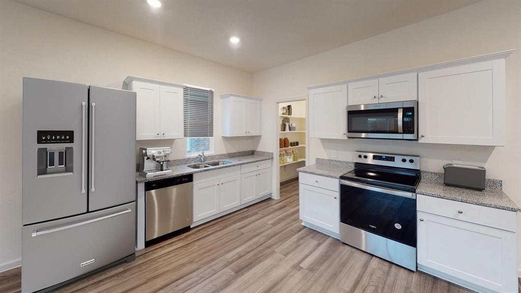 819 Independence Trail Josephine, TX 75173 - Photo 6 of 10 a kitchen with granite countertop a refrigerator stove and sink