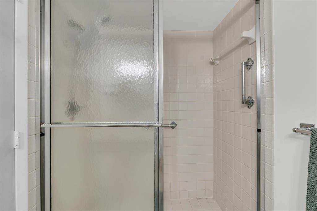 3920 Inverrary Boulevard, Unit 104C Lauderhill, FL 33319 - Photo 12 of 15 a bathroom with a glass shower door