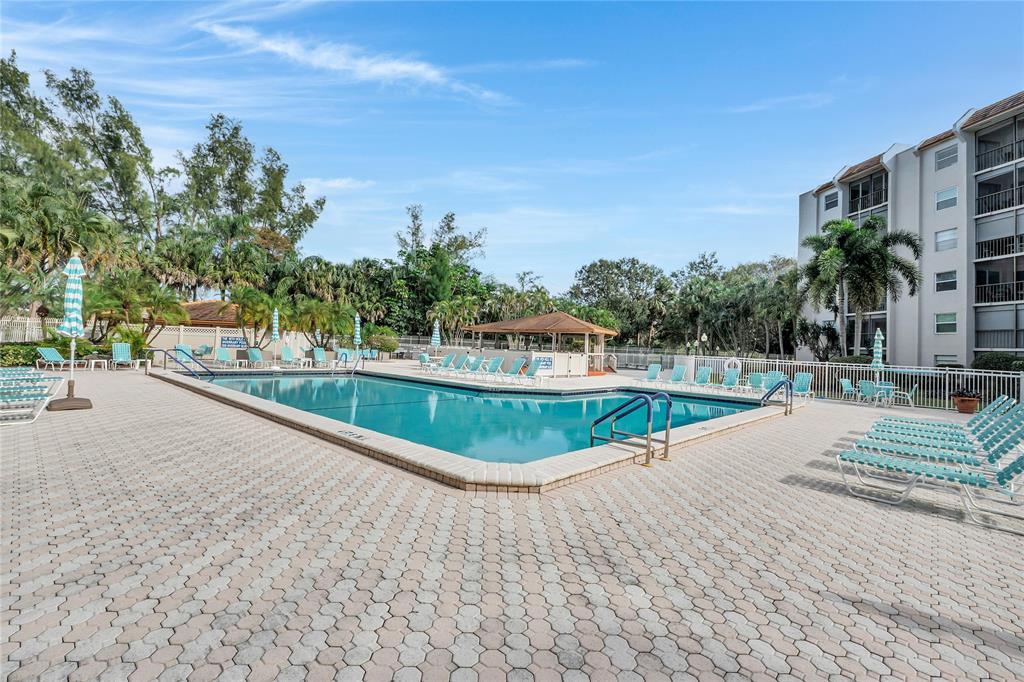3920 Inverrary Boulevard, Unit 104C Lauderhill, FL 33319 - Photo 14 of 15 a view of swimming pool with a yard